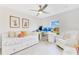 Sunlit bedroom with a daybed, accent chair, white desk, and a window offering serene outdoor views at 10226 Vickers Ridge Dr, Orlando, FL 32829