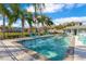 Relaxing community pool with lounge chairs and palm trees providing shade on a sunny day at 10226 Vickers Ridge Dr, Orlando, FL 32829