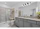 Modern bathroom with double sinks, granite countertop and walk-in shower at 10358 Spring Arbor Ln, Winter Garden, FL 34787