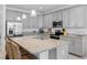 Spacious kitchen island with granite countertops, stainless steel appliances, and ample cabinet space at 10358 Spring Arbor Ln, Winter Garden, FL 34787