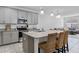 Bright kitchen featuring granite countertops, stainless steel appliances, and a breakfast bar with wicker chairs at 10358 Spring Arbor Ln, Winter Garden, FL 34787