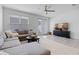 Cozy living room with ample seating, neutral tones, and a ceiling fan at 10358 Spring Arbor Ln, Winter Garden, FL 34787