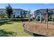 Community playground featuring modern play equipment surrounded by lush green grass at 10358 Spring Arbor Ln, Winter Garden, FL 34787