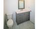 Bathroom with tiled floor, gray vanity with marble top, and bronze fixtures at 1041 Vihlen Rd, Sanford, FL 32771