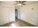 Bright bedroom featuring hardwood floors, a ceiling fan, and a spacious closet at 1041 Vihlen Rd, Sanford, FL 32771