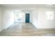 Bright, open living room with gray wood floors and a blue front door at 1041 Vihlen Rd, Sanford, FL 32771