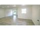 Bright, open living room with gray wood floors and two large windows at 1041 Vihlen Rd, Sanford, FL 32771