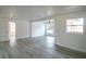 Bright, open living room with gray wood floors and a large window at 1041 Vihlen Rd, Sanford, FL 32771