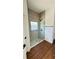 Modern bathroom featuring a glass shower with tiled walls and wood-style flooring at 11 Spruce Ln, Ocala, FL 34472
