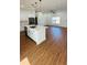 Modern, open-concept kitchen and living area features laminate floors, stainless steel appliances, and pendant lighting at 11 Spruce Ln, Ocala, FL 34472
