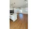 Stylish open-concept kitchen, and living area featuring laminate floors, quartz countertops, and stainless steel appliances at 11 Spruce Ln, Ocala, FL 34472