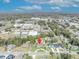 An aerial view of the property is marked by a red pin, highlighting its location amidst the surrounding neighborhood and lush greenery at 111 Clark St, Oviedo, FL 32765