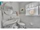 Bright bathroom featuring a white sink, toilet, and window with natural light at 111 Clark St, Oviedo, FL 32765