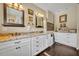 Elegant bathroom boasting granite countertops, double sinks, and white cabinetry at 111 Clark St, Oviedo, FL 32765