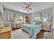 Comfortable bedroom with a ceiling fan, carpeting, and bright natural light at 111 Clark St, Oviedo, FL 32765