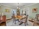 Charming dining room featuring a classic wooden table set, elegant decor, and seamless connection to other living spaces at 111 Clark St, Oviedo, FL 32765