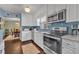 Modern kitchen features stainless steel appliances, white cabinets, and tiled backsplash, creating a stylish and functional cooking space at 111 Clark St, Oviedo, FL 32765