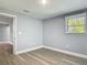 Cozy bedroom with wood-look floors, a window with natural light, and neutral wall color at 1125 E Hubbard Ave, Deland, FL 32724