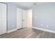 Spacious bedroom featuring wood-look floors, a closet with doors, and a doorway at 1125 E Hubbard Ave, Deland, FL 32724