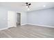 Bright bedroom with wood floors, trim, and a view into the tiled bathroom at 1125 E Hubbard Ave, Deland, FL 32724