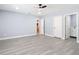 A light-filled bedroom featuring wood floors and entryways to the bathroom and closet at 1125 E Hubbard Ave, Deland, FL 32724