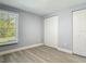 Bedroom featuring wood-look floors, a closet, and one window providing natural light at 1125 E Hubbard Ave, Deland, FL 32724