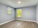 Bright bedroom featuring wood-look floors, a window with natural light, and neutral wall color at 1125 E Hubbard Ave, Deland, FL 32724