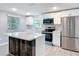 A recently remodeled kitchen featuring stainless steel appliances, shaker cabinets and a large island at 1125 E Hubbard Ave, Deland, FL 32724