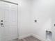 The laundry room features tile floor and a white door with utility hookups at 1125 E Hubbard Ave, Deland, FL 32724