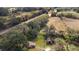 Aerial view of a wooded lot with a home and a small shed near railroad tracks at 1213 Cr 652, Bushnell, FL 33513