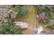 Aerial view of a wooded lot with a home and a small shed with a rusted metal roof at 1213 Cr 652, Bushnell, FL 33513