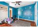 Bedroom with blue walls, ceiling fan, hardwood floors, and closet space at 1213 Cr 652, Bushnell, FL 33513