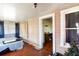 A bedroom with an adjacent room, featuring wood paneling and light from several windows at 1213 Cr 652, Bushnell, FL 33513