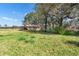 Exterior view of an old house in a rural setting surrounded by grass and trees at 1213 Cr 652, Bushnell, FL 33513