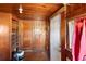 A wood-paneled room with an adjacent closet and an exterior door at 1213 Cr 652, Bushnell, FL 33513