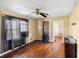 A living room with hardwood floors and a ceiling fan, with natural light from the windows at 1213 Cr 652, Bushnell, FL 33513