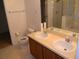 Bathroom featuring double sinks, a bathtub, and a glass-enclosed shower at 13812 Cepheus Dr, Orlando, FL 32828