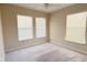 Bright carpeted bedroom featuring three windows and neutral walls at 13812 Cepheus Dr, Orlando, FL 32828