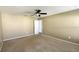 Spacious carpeted bedroom featuring a ceiling fan and neutral paint at 13812 Cepheus Dr, Orlando, FL 32828