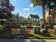 View of the Community Pool and Building, surrounded by lush landscaping at 13812 Cepheus Dr, Orlando, FL 32828