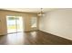 Sunlit dining area featuring sliding glass doors and contemporary chandelier at 13812 Cepheus Dr, Orlando, FL 32828