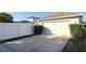 A home's exterior featuring a two-car garage, white vinyl fence, and well-maintained landscaping at 13812 Cepheus Dr, Orlando, FL 32828