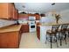 Kitchen featuring light countertops and stainless steel bar seating at 13812 Cepheus Dr, Orlando, FL 32828