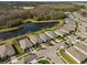 An aerial view of homes nestled by a pond, framed with a yellow property line at 17826 Blazing Star Cir, Clermont, FL 34714