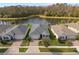 Aerial view of homes showcasing backyard pond and well-maintained landscaping at 17826 Blazing Star Cir, Clermont, FL 34714