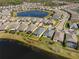 An aerial view displays homes bordering a lake, complemented by a highlighted yellow property line at 17826 Blazing Star Cir, Clermont, FL 34714