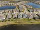 An aerial view shows homes bordering a lake, enhanced by a bright property line at 17826 Blazing Star Cir, Clermont, FL 34714