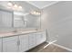 Bathroom featuring double vanity with quartz countertop, modern lighting and wood-look tile flooring at 17826 Blazing Star Cir, Clermont, FL 34714