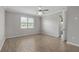 A clean, empty bedroom featuring a ceiling fan and wood-look tile flooring at 17826 Blazing Star Cir, Clermont, FL 34714