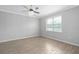 Empty bedroom with a ceiling fan, a window, and wood-look tile flooring at 17826 Blazing Star Cir, Clermont, FL 34714